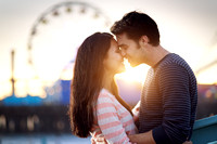 romantic couple in front of santa monica amusement park